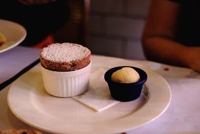 Coffee cup and cake on table