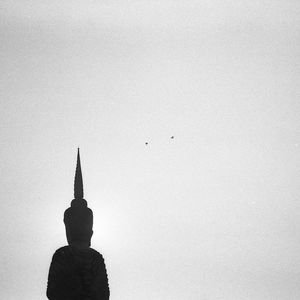 Silhouette of statue against sky