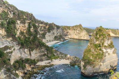 Scenic view of sea and mountains against sky