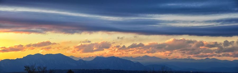 Scenic view of snowcapped mountains against sky during sunset