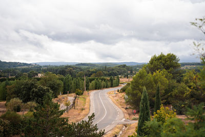 High angle view of road amidst trees against sky