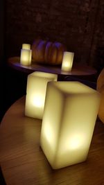 Close-up of lit candles on table