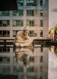 Statue in front of building in city