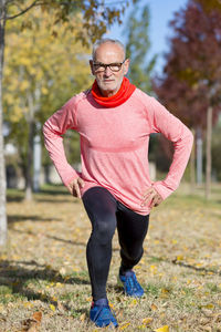 Senior man exercising on field at park