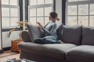 Young woman using laptop at home