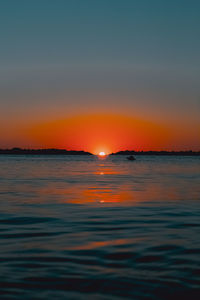 Scenic view of sea against romantic sky at sunset