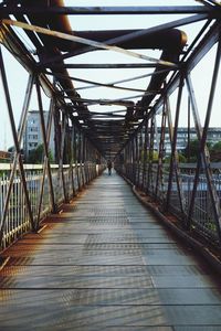 Man on bridge against sky