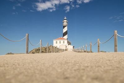 View of lighthouse on beach against sky