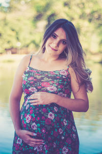 Portrait of a beautiful young woman standing outdoors