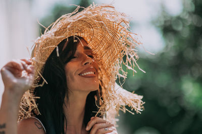 Close-up portrait of a young woman wearing hat