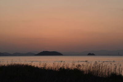 Scenic view of lake against sky during sunset