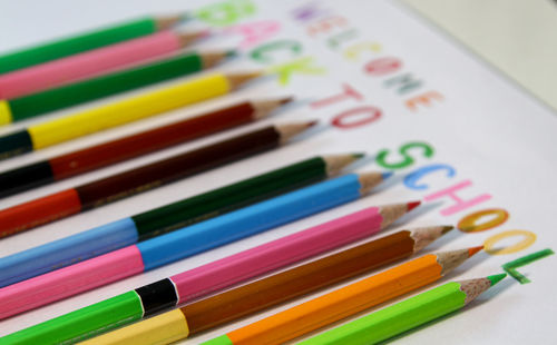 Close-up of multi colored pencils with text