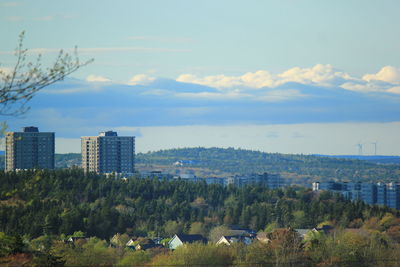 Buildings against cloudy sky