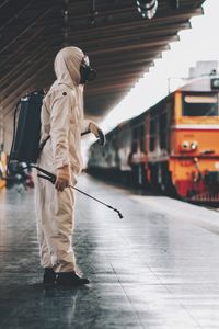 Rear view of man walking on footpath in city