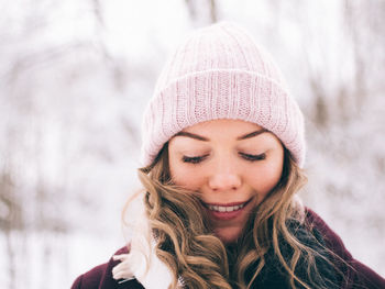 Close-up of young woman wearing knit hat 