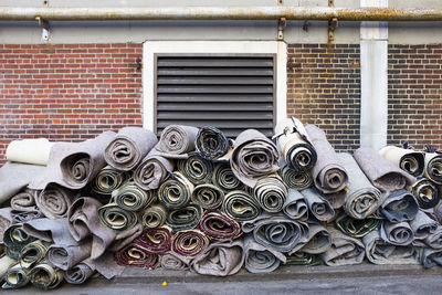 Rolled up carpets outside building