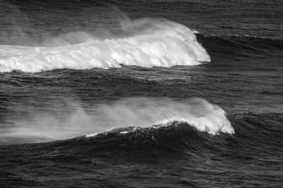 Waves breaking against sea