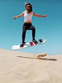 Full length of man jumping on beach