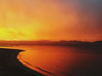 Scenic view of sea against orange sky