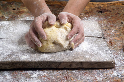 Cropped image of hands preparing food on cutting board