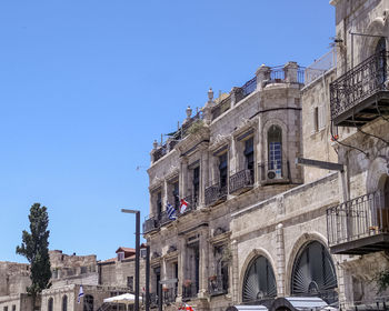 Low angle view of buildings against clear blue sky