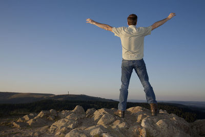 Full length of woman standing on rock