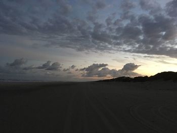 Scenic view of dramatic sky over silhouette landscape