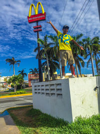 Low angle view of man sign against sky