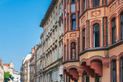 Low angle view of buildings against blue sky