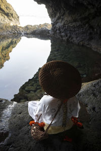 Rear view of man standing on rock