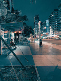 Illuminated city street and buildings at night