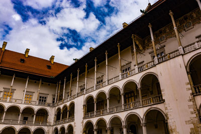 Low angle view of building against cloudy sky