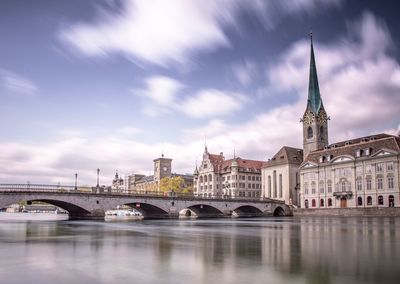 Bridge over river with buildings in background