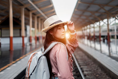 Portrait of beautiful young woman at railroad station