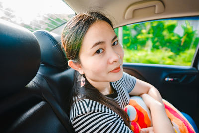 Portrait of cute girl sitting in car