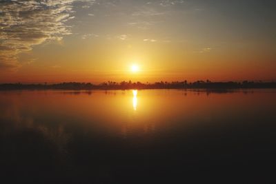 Scenic view of lake against sky during sunset