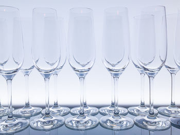 Close-up of wine glasses in row