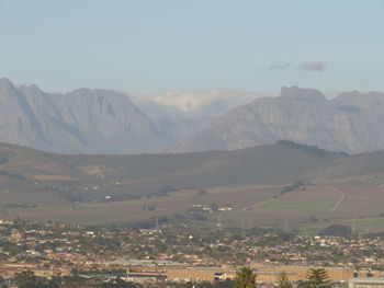 High angle view of townscape and mountains against sky