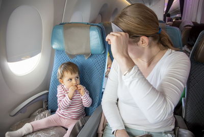 Mother with daughter at airplane