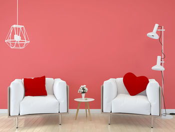 Red chairs and table against wall at home