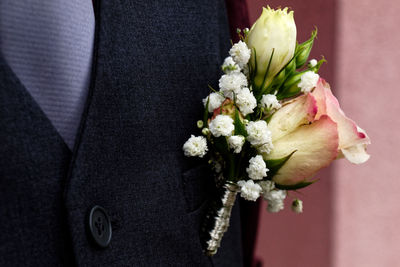 Close-up of boutonniere on bridegroom suit
