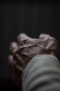 Close-up of hand over black background