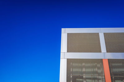 Low angle view of building against clear blue sky