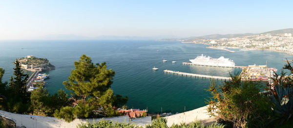 High angle view of city by sea against sky