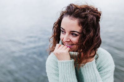 Portrait of woman against sea in background