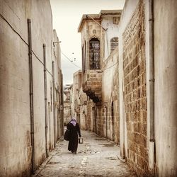 Rear view of woman walking in city