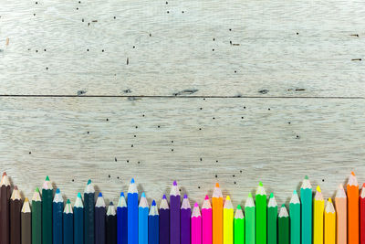 Close-up of multi colored pencils against white background