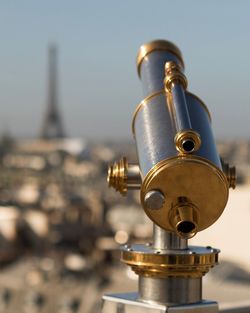 Close-up of coin-operated binoculars against sky