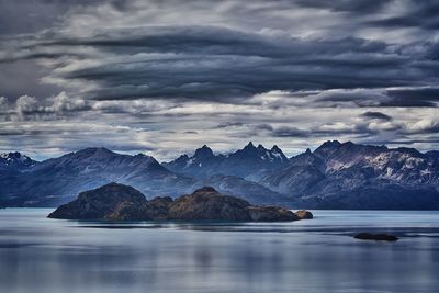 Scenic view of sea and mountains against sky