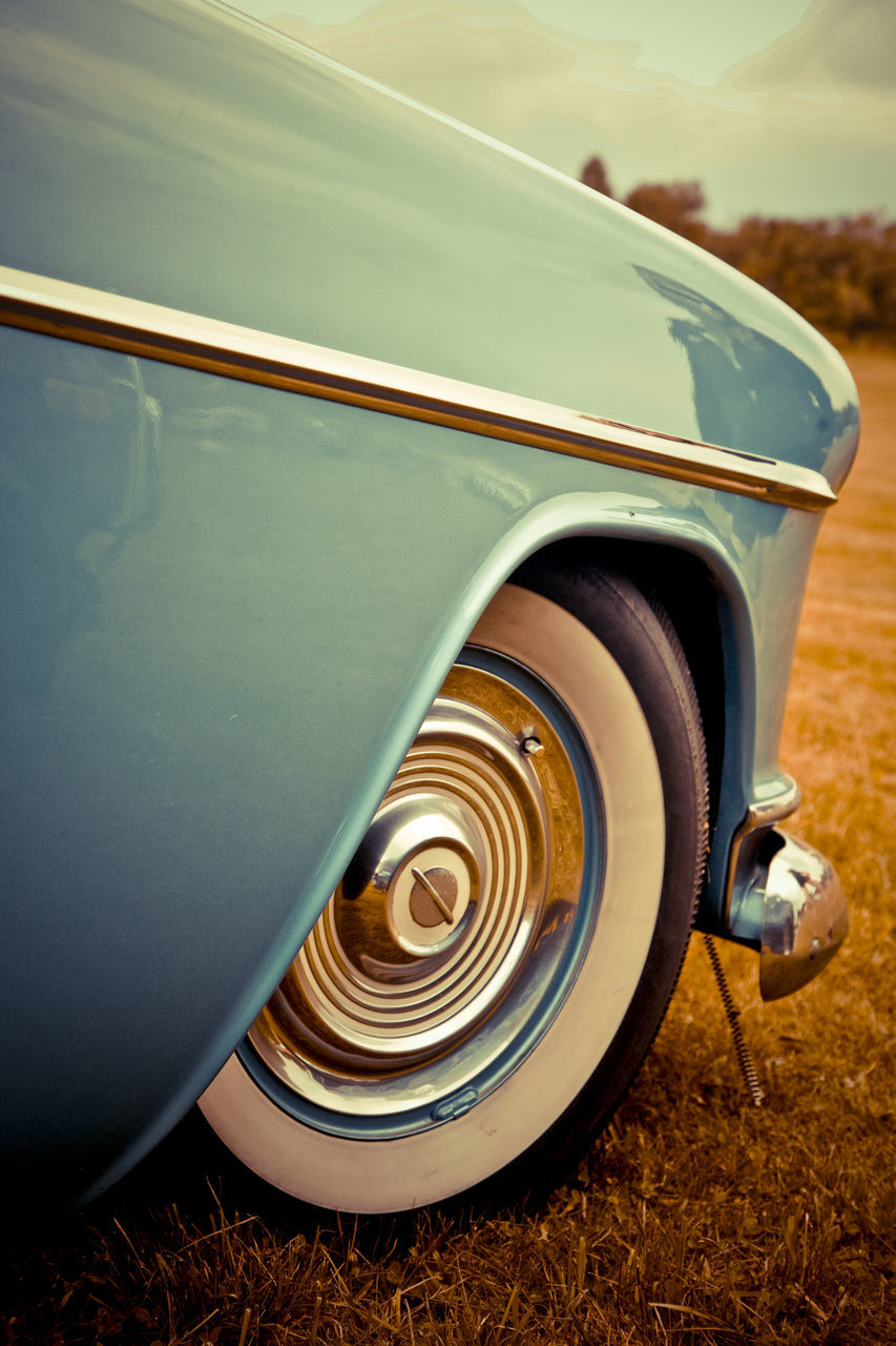 CLOSE-UP OF TIRE AGAINST CAR